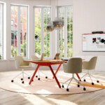 Modern collaborative meeting room with table, rolling chairs, digital display, and mobile whiteboard