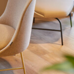 Close-up of a white upholstered armless chair.