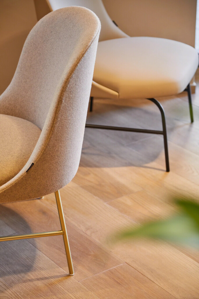 Close-up of a white upholstered armless chair.