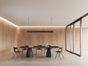 Quadra chairs around a large round table against a wood background.