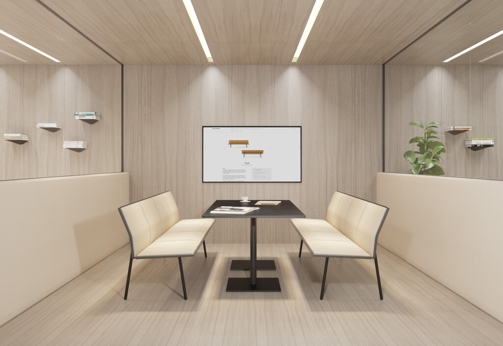 Minimalist meeting room with a table and four cream chairs facing a screen in the middle of the room.