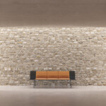 Wooden bench inside brick wall space