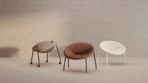 Three multicolor lounge chairs displayed in a beige room.