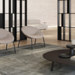 Interior room with two lounge chairs and a sofa around a mini black table