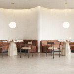 Perxa chairs around round tables in a lounge environment.