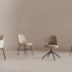 Collection of chairs against neutral background