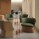 Upholstered manto chairs arranged around coffee tables.